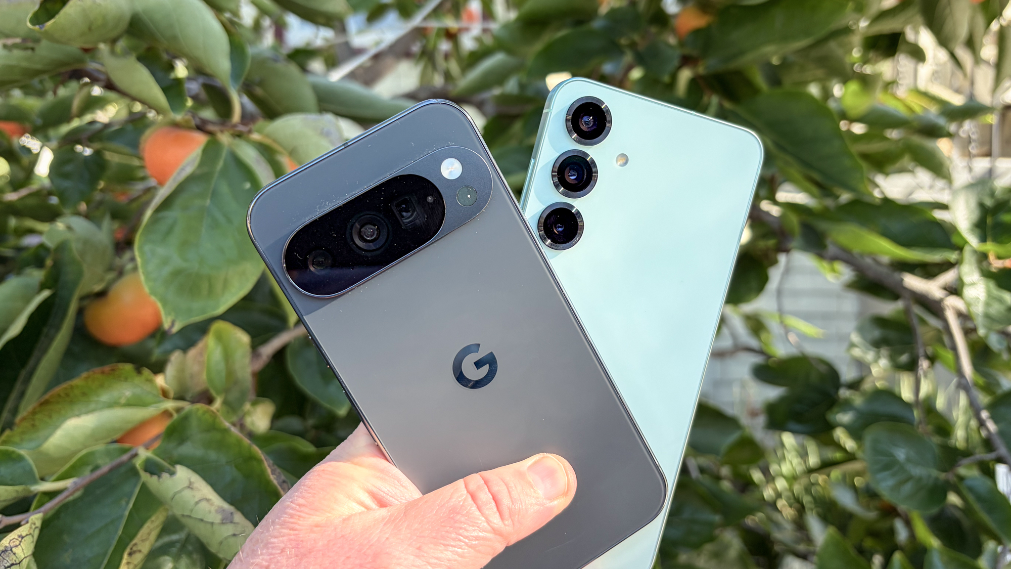 Pixel 10 Pro and Galaxy S25 Plus held in hand
