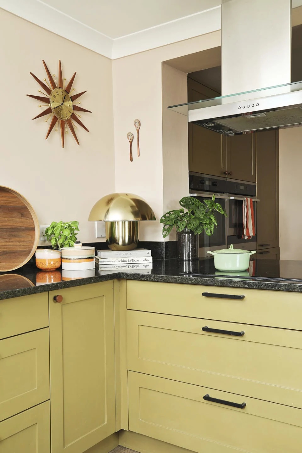 green kitchen units and hob