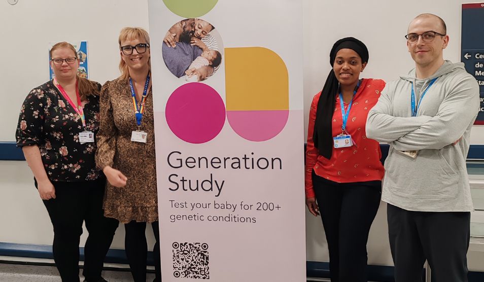 Four healthcare professionals stand either side of a promotional poster for a research study.