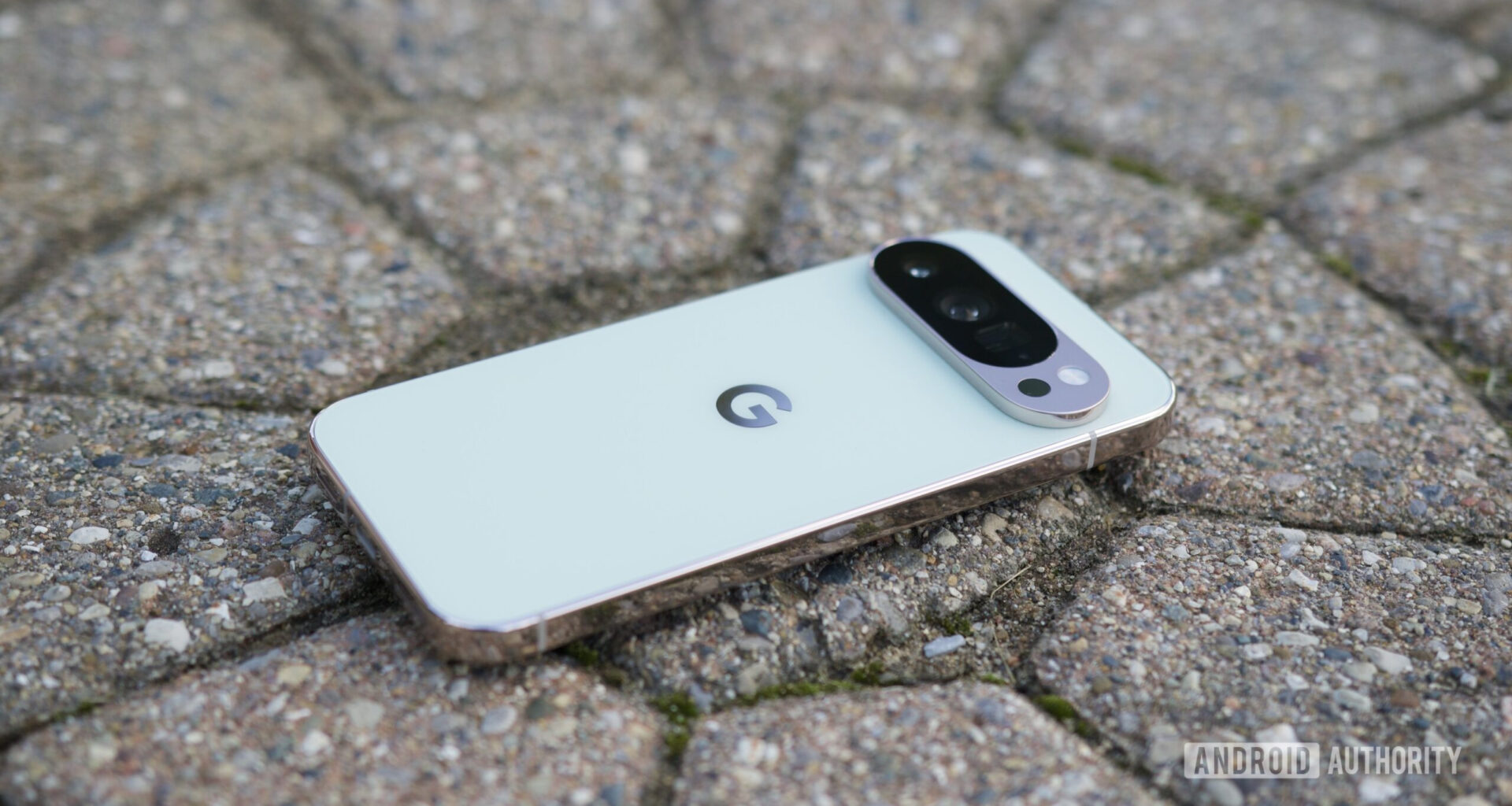 The Google Pixel 10 Pro laying face-down on the pavement.