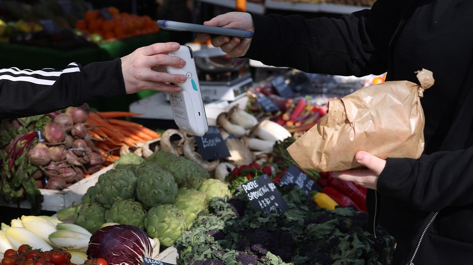 Customer pays by phone at farmers market.