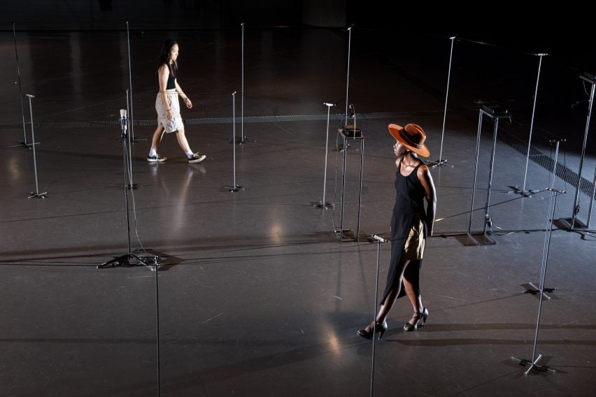 people walking around poles