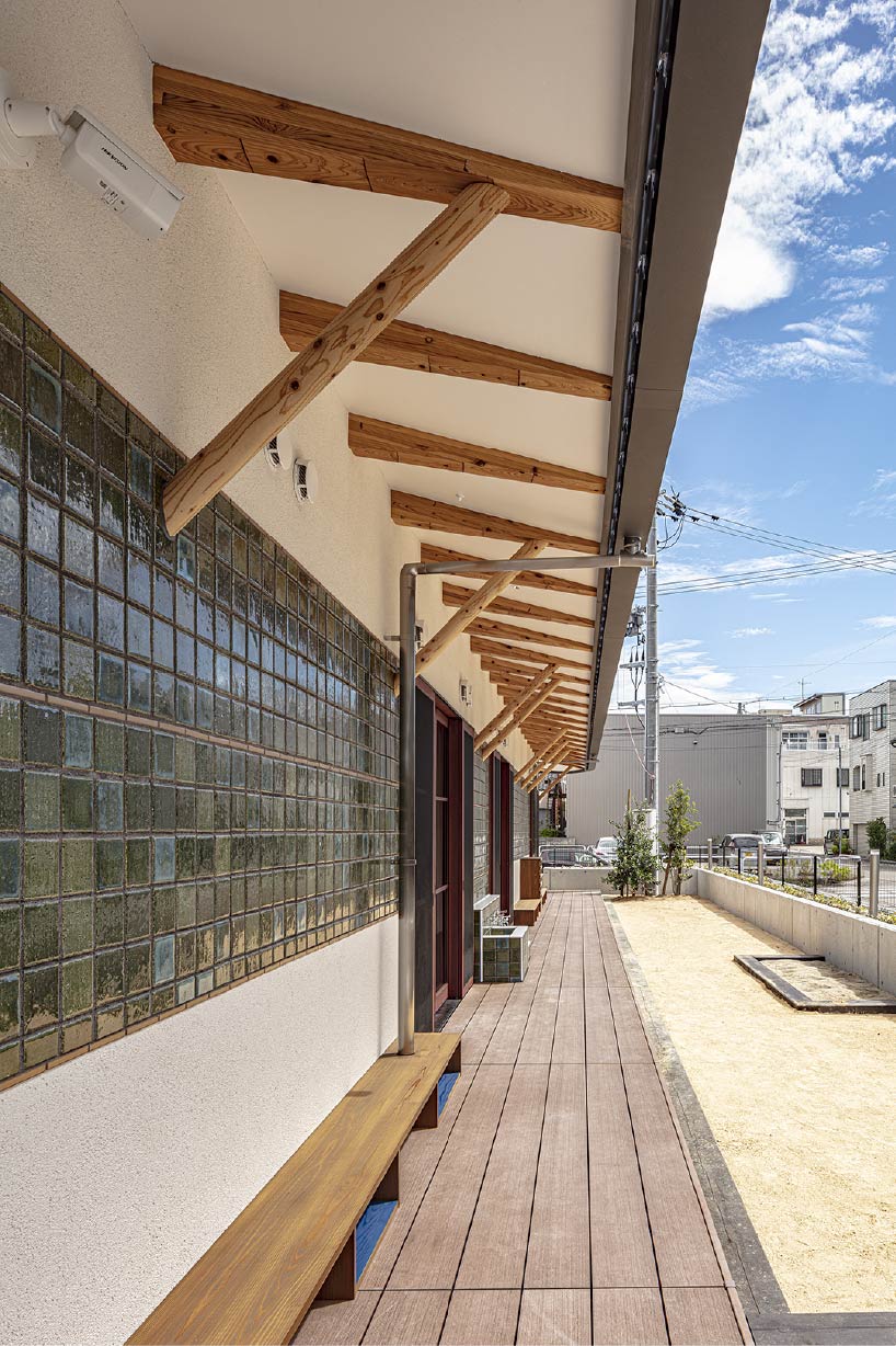 curved wooden frame shapes light-filled daycare center in japan encouraging playful learning