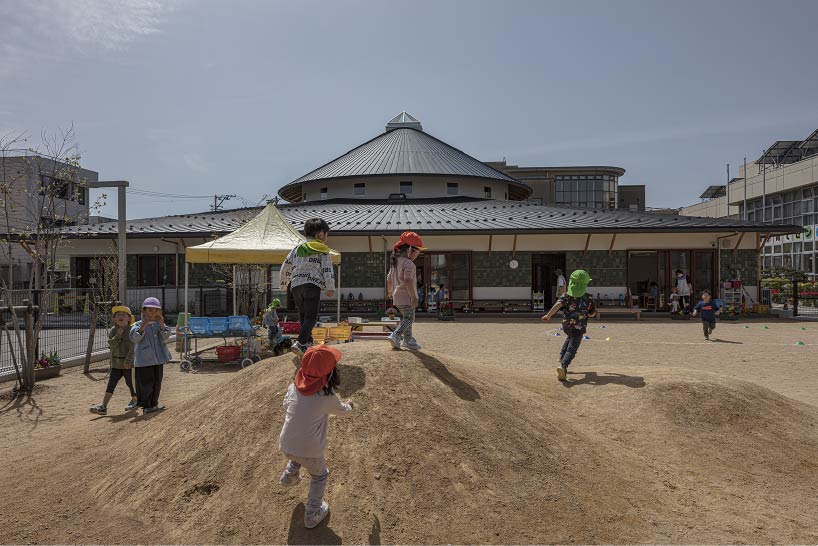 curved wooden frame shapes light-filled daycare center in japan encouraging playful learning