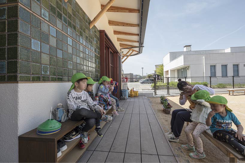 curved wooden frame shapes light-filled daycare center in japan encouraging playful learning