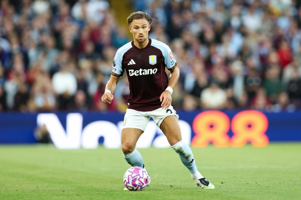 Matty Cash looking at the ball while playing for Aston Villa