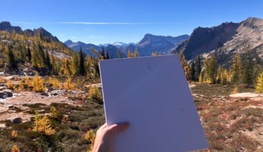 hand-holding-starlink-mini-dish-with-mountains-in-background