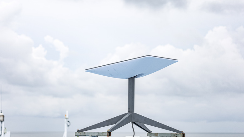 A Starlink logo and device atop a keyboard