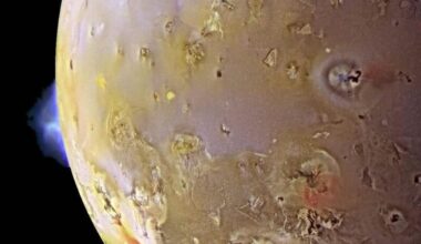 Mottled world, with a volcanic plume on one edge.