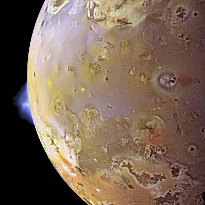 Mottled world, with a volcanic plume on one edge.