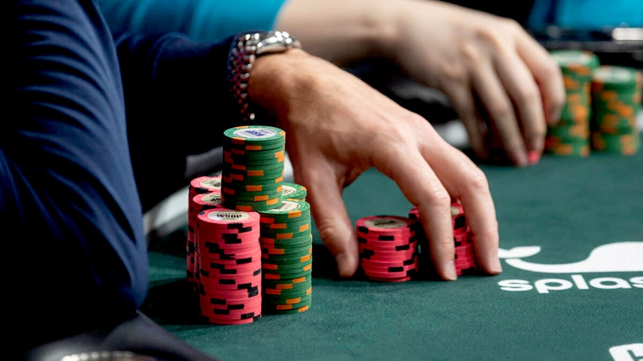 People sitting at a poker table in Las Vegas.