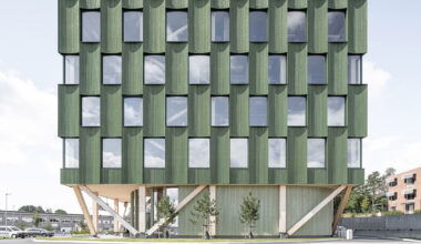 green timber curves sculpt rhythmic facade for office building in norway