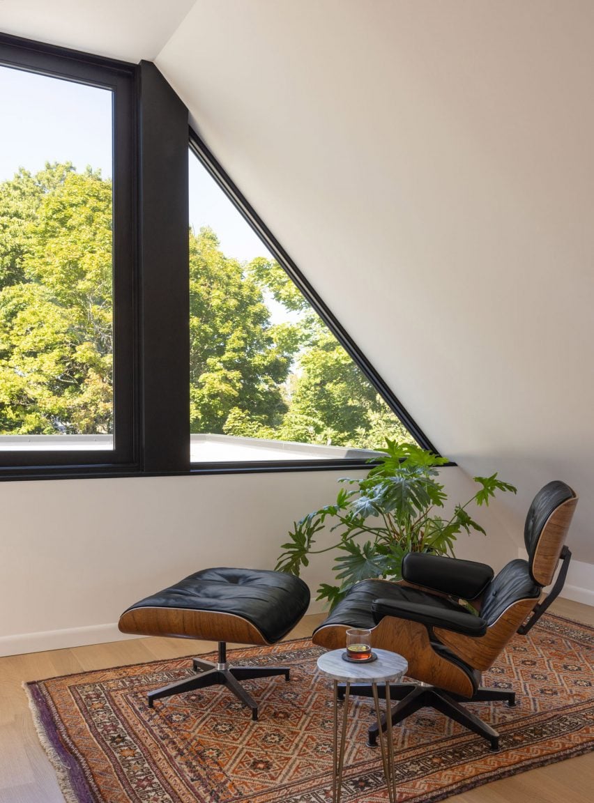 Eames Lounge in front of black-framed window
