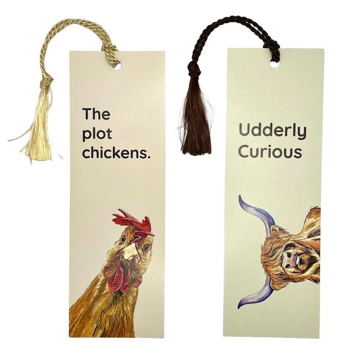 two bookmarks with ribbons in them. the one on the left has a chicken on it with text above it that reads The Plot Chickens. The one on the right has a longhorn cow with text that reads Udderly Curious