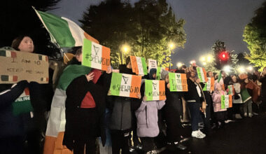 Protesters let off pink smoke during asylum demonstration at Citywest