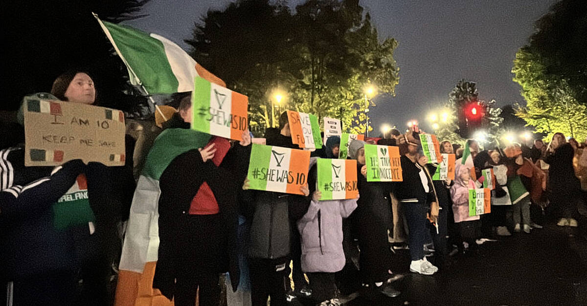 Protesters let off pink smoke during asylum demonstration at Citywest