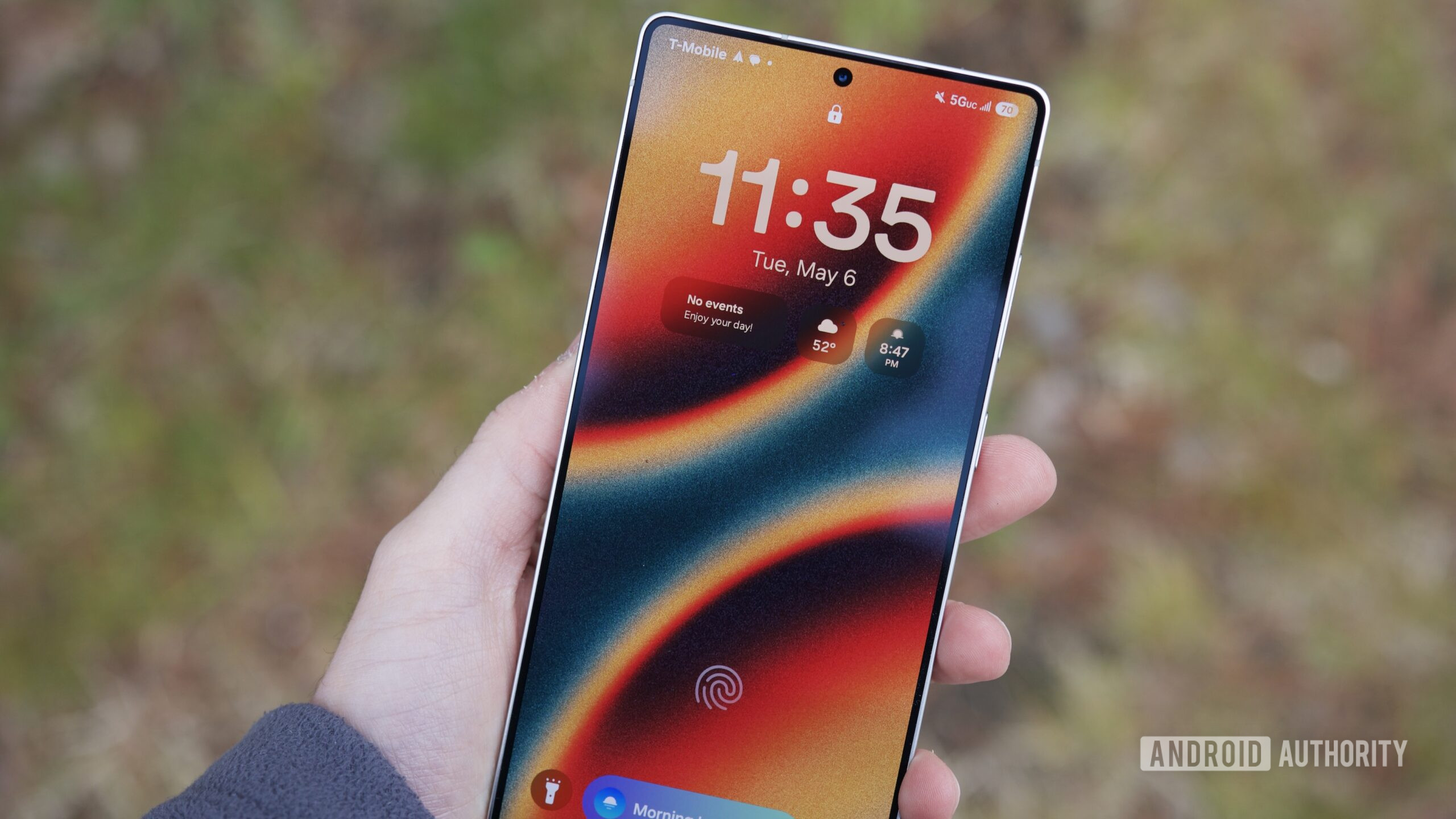 Someone holding the Samsung Galaxy S25 Ultra with its display turned on.