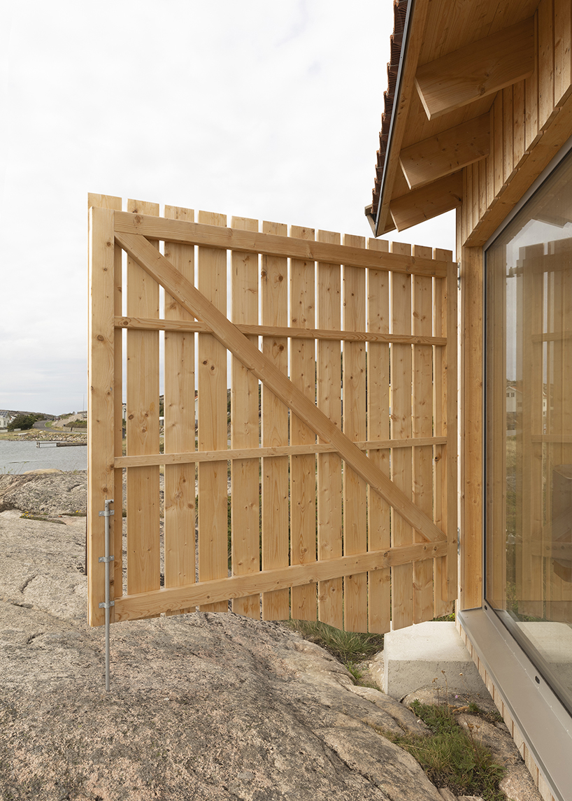 untreated wooden cladding wraps vernacular sauna sövall on sweden's rocky shoreline