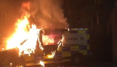A police van on fire at the scene of the protest