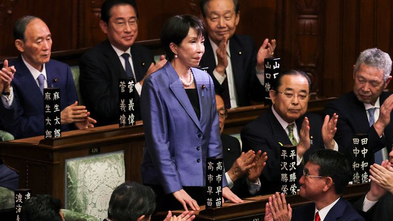 Sanae Takaichi reacts as she receives applause after being elected as prime minister. Pic: Reuters