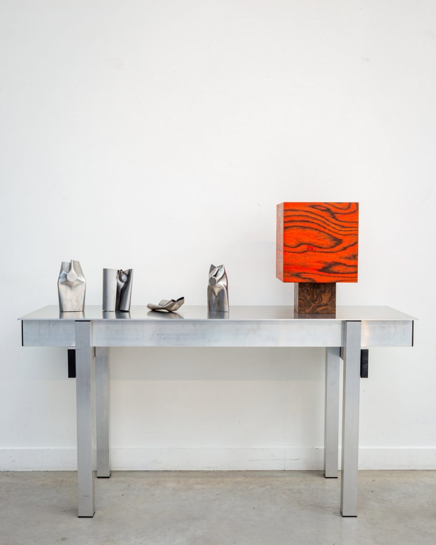 Metal candle holders and red veneer lamp in The Car Boot Sale exhibition by Slancha