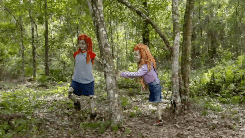 a gif of two stop motion figures in a forest in a film by Swoon