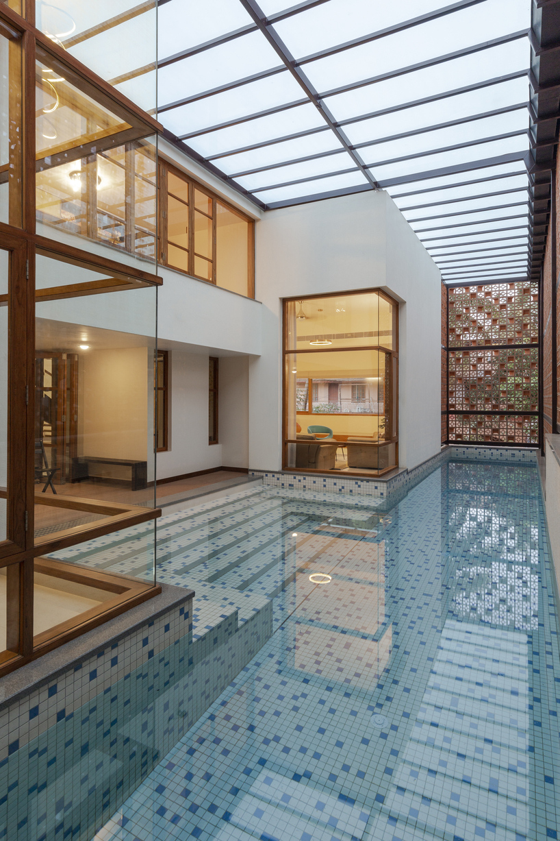 perforated terracotta screens enclose pool pavilion within indian residence