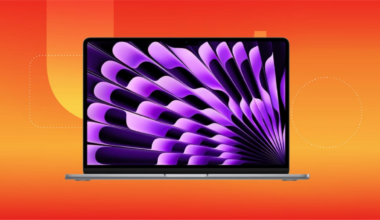 A gray MacBook Air displaying purple and black wallpaper, set against an orange gradient background.
