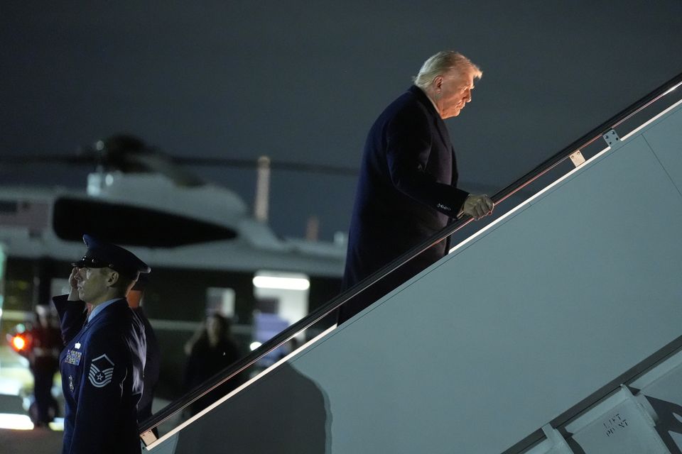 President Donald Trump boards Air Force One at Joint Base Andrew on his way to Mar-a-Lago (Manuel Balce Ceneta/AP)
