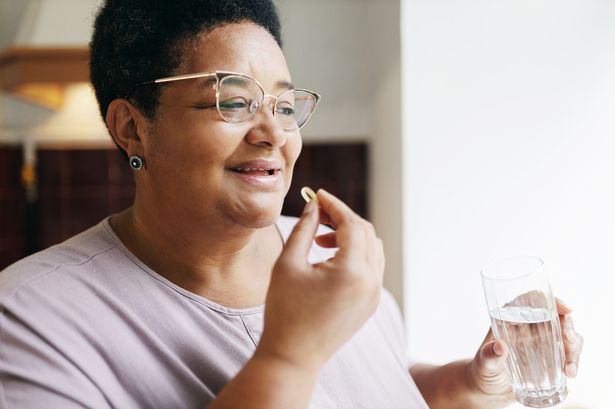 Woman taking supplement