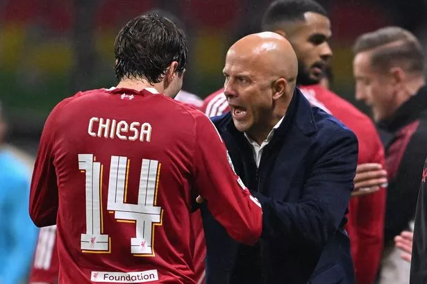 Liverpool's Dutch manager Arne Slot speaks with Liverpool's Italian striker #14 Federico Chiesa from the sidelines during the UEFA Champions League football match between Eintracht Frankfurt and Liverpool FC in Frankfurt, western Germany on October 22, 2025. (Photo by Kirill KUDRYAVTSEV / AFP) (Photo by KIRILL KUDRYAVTSEV/AFP via Getty Images)     