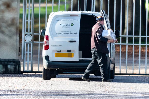 A delivery driver dropping off a case of champagne