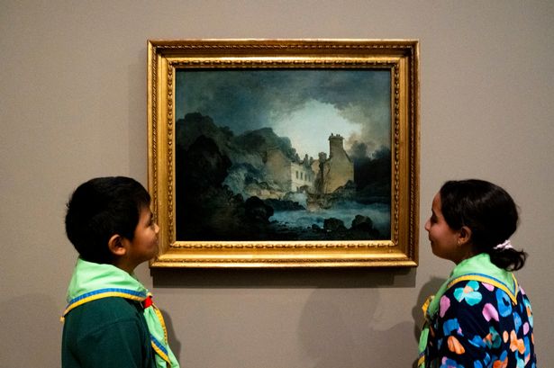 A troop of scouts look at 'The Rising Squall, Hot Wells, from St Vincent's Rock, Bristol' by Joseph Mallord William Turner  during a press preview of the Turner/Constable exhibition at Tate Britain, London.