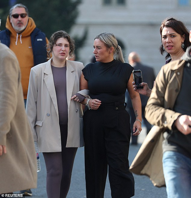 She looked visibly overwhelmed as reporters gathered outside court to speak to her