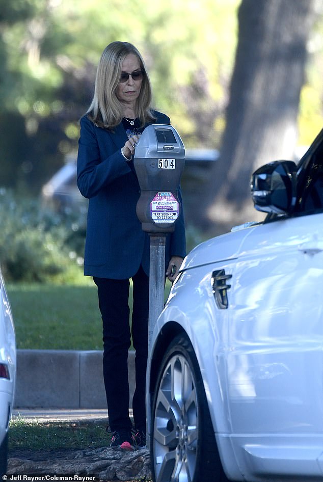 Lovely Barbara feeds the meter in Beverly Hills during a trip into town for a meeting