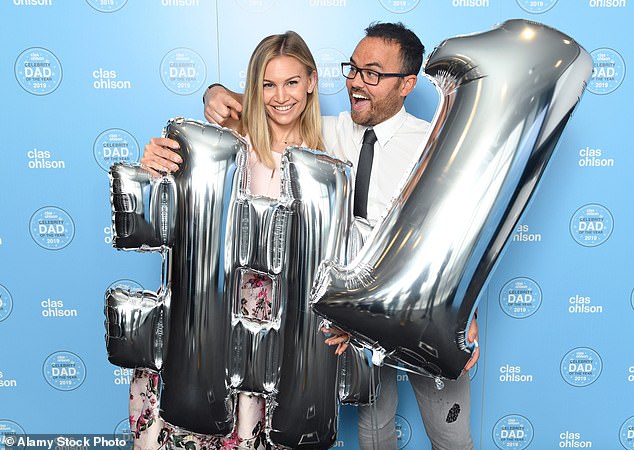 Jonathan celebrates with Anna after winning a celebrity dad of the year award in 2019