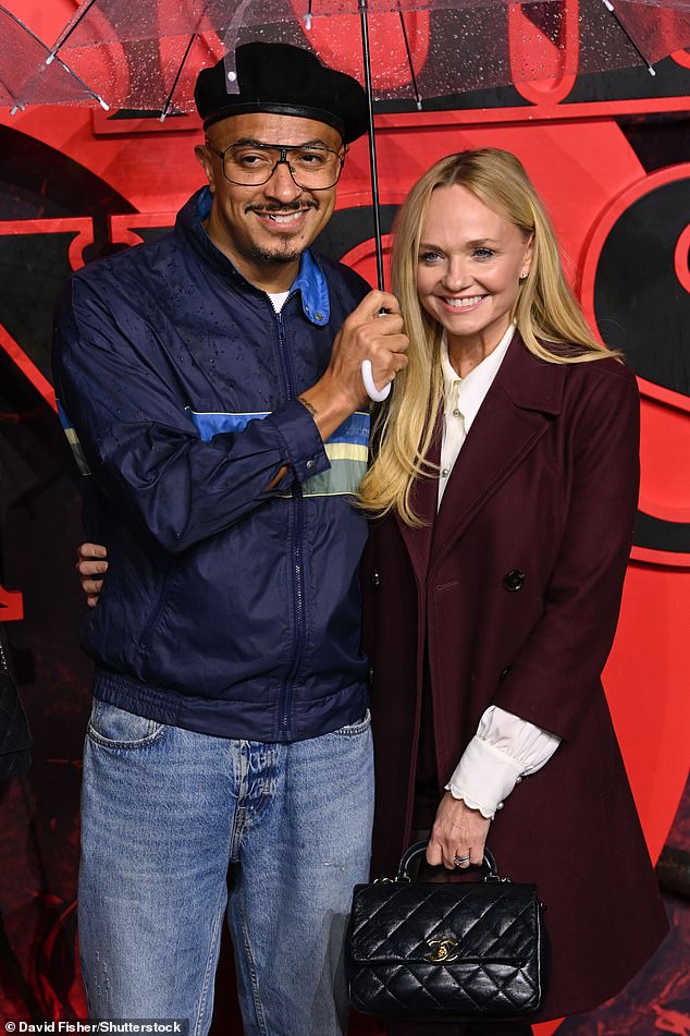 Jade Jones and Emma Bunton battled the rain as they gathered underneath an umbrella