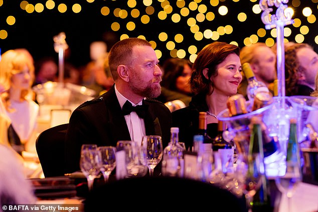 The couple, who married in 2022, sat side by side as they listened to tributes from the stage