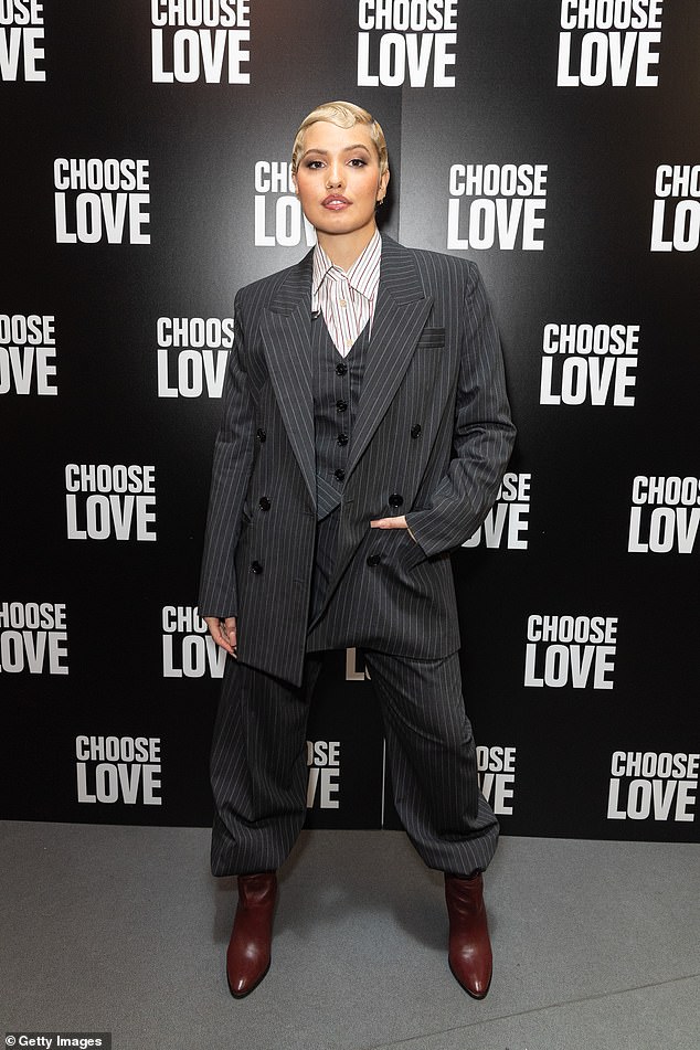 Singer Mabel, 29, commanded attention in a grey pinstripe three-piece power suit paired with red leather boots