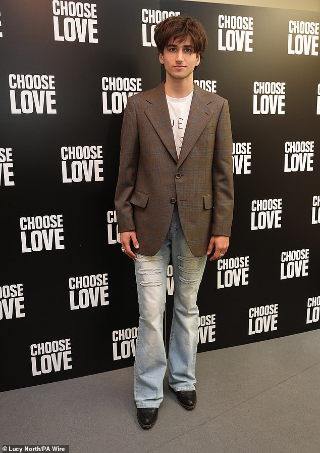 Actor Sebastian, 23, cut a dapper yet relaxed figure in a brown tweed blazer paired with faded blue denim jeans