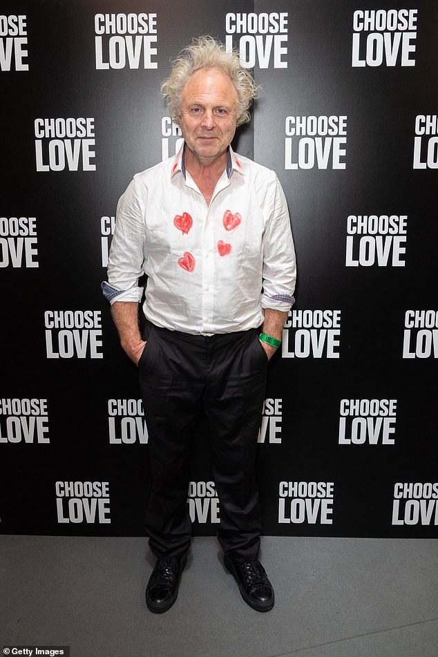 British artist Charlie, 62, sported a white shirt featuring red heart prints at the front, styled with smart black trousers