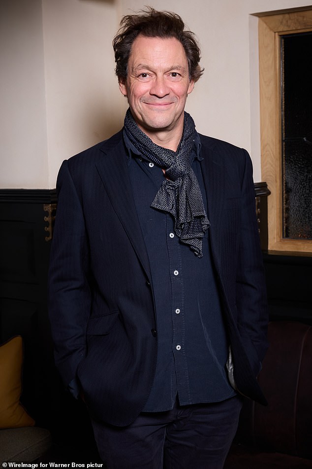 Dominic West added a fashionable black and white scarf to his ensemble