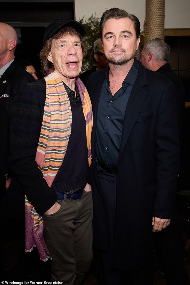 The actor kept his look simple in a satin shirt and black tailored jacket as he posed with the Rolling Stones legend, 82, who wore a bright orange and purple scarf and black cap