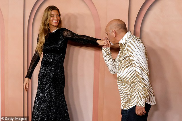 Gisele was joined by Christian Louboutin, who kissed her hand