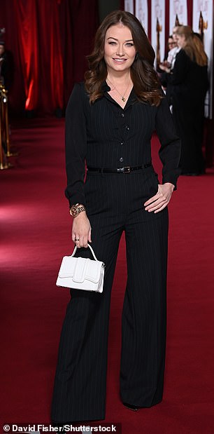 Jess Impiazzi was stylish in all black and toted a chic white handbag