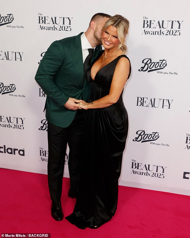 The television personality, 45, showcased her cleavage in a plunging black dress as she cosied up to her toyboy boyfriend Paolo Margaglione, 33