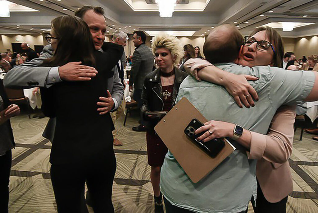 people hugging at NAMI breakfast
