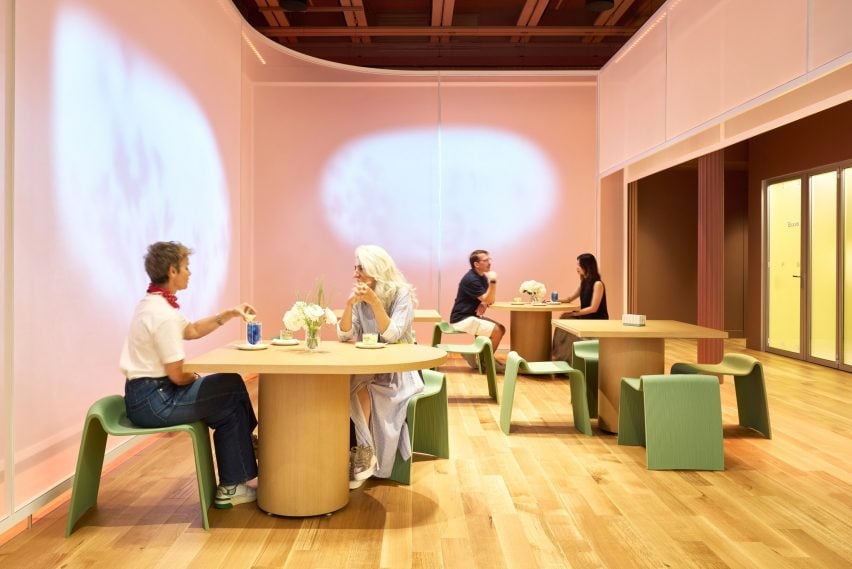 Fabric partitions with digital projections behind a seating area