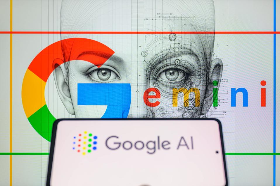 The Google AI logo is being displayed on a smartphone with Gemini in the background.