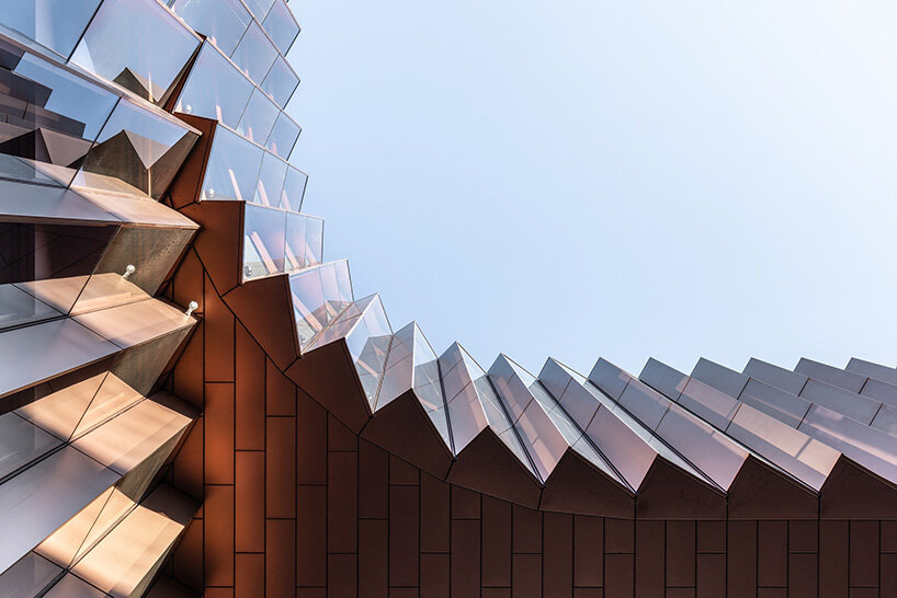 BIG's timber 'snakes' rise as skypark business center nears completion in luxembourg